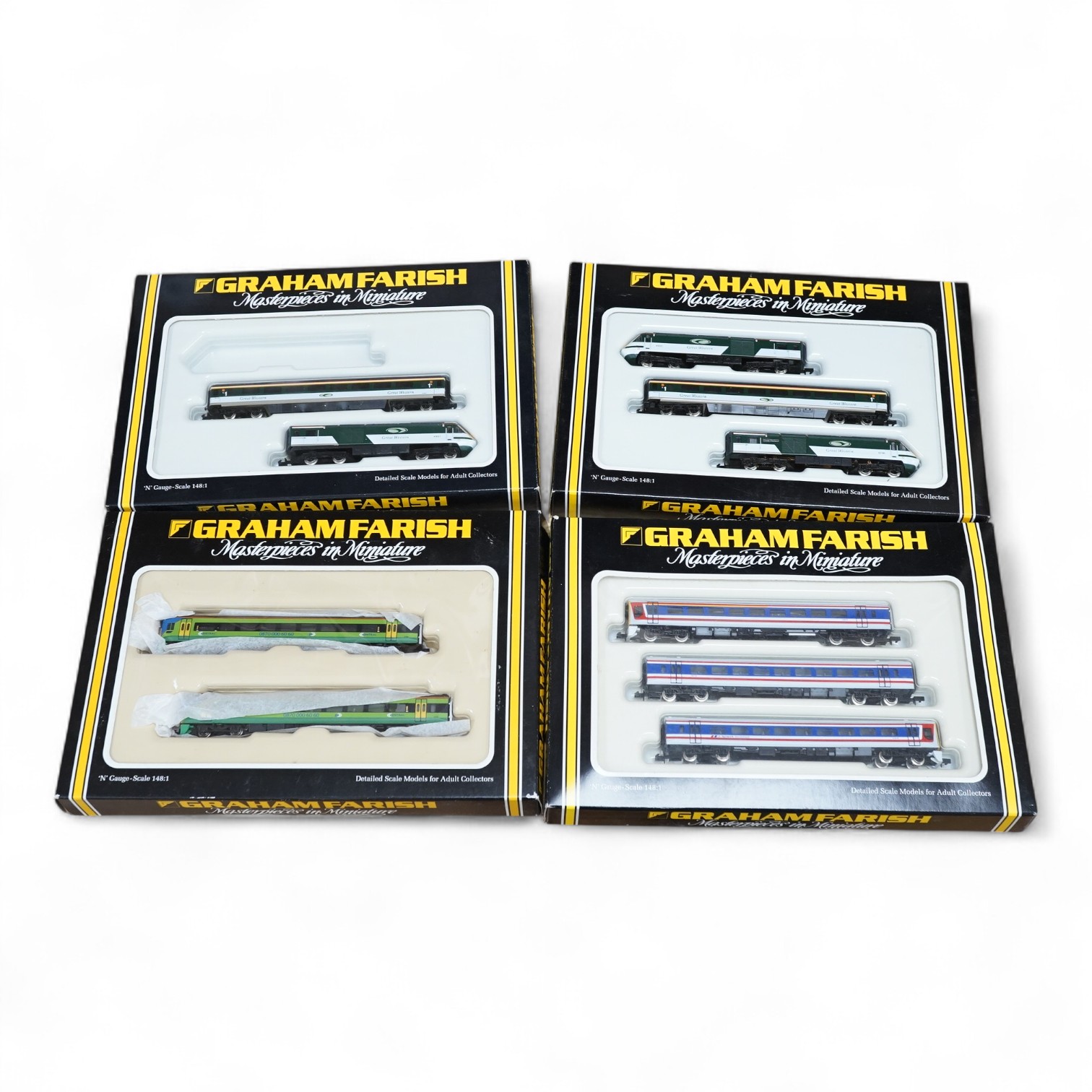 Four boxed Graham Farish N gauge railway train packs; a NSE Class 159 3-car set (8748), a Great Western HST 125 train (8122), a Central Trains 158 2-car DMU (371550) and a Great Western HST 125 train (8122), missing the